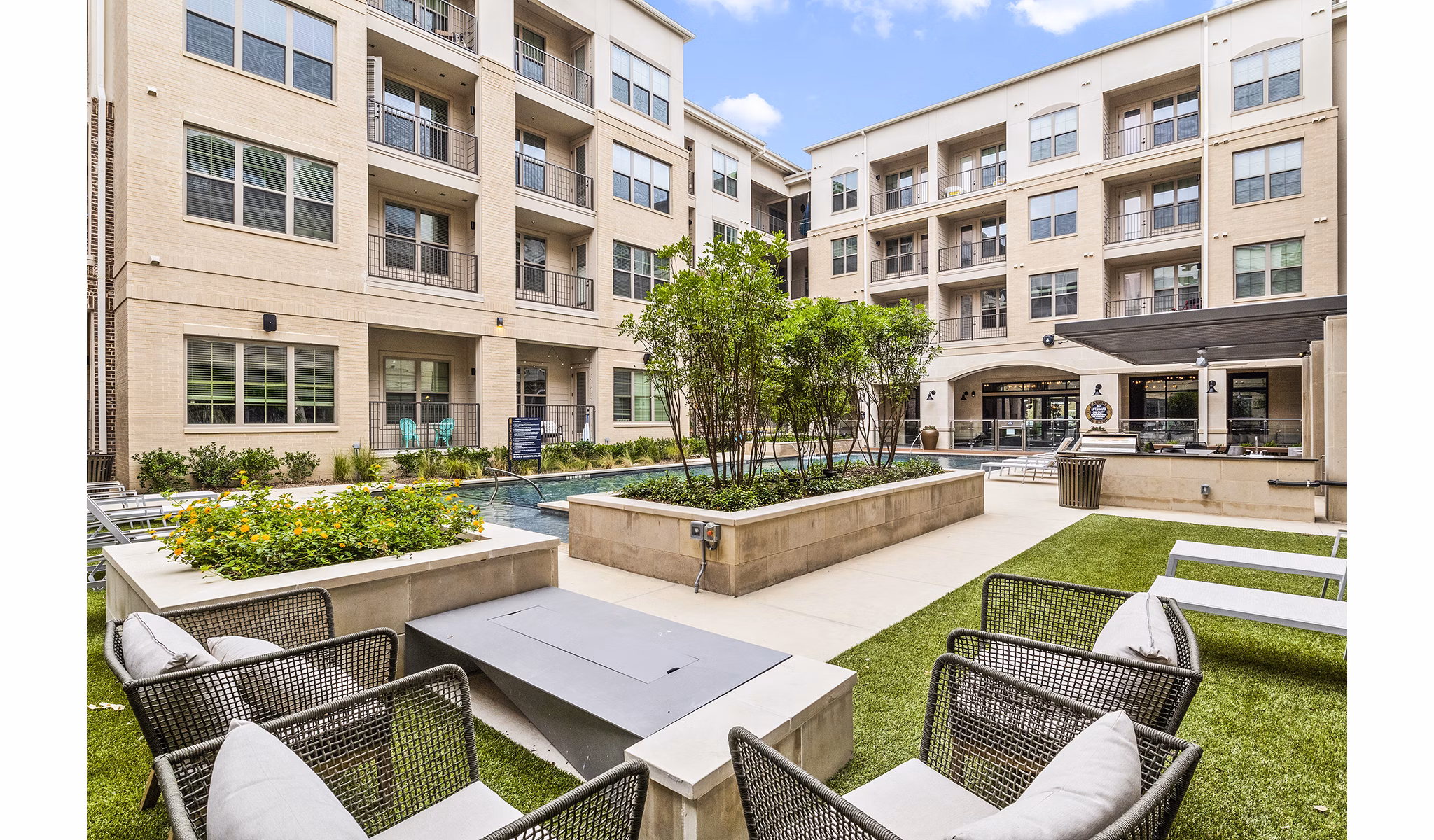 Pool with sun deck at Elan Addison Grove Apartments: Luxury space in prime location offering relaxation and comfort