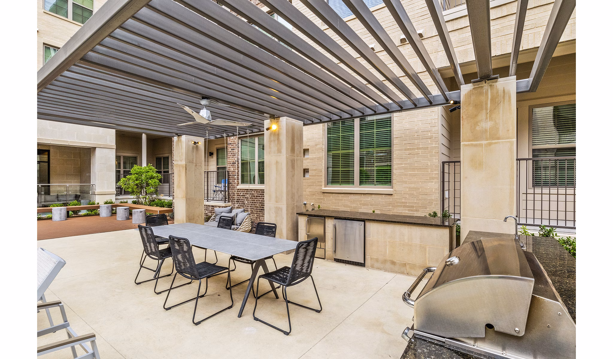 Modern grill area with seating at Elan Addison Grove Apartments, perfect for outdoor dining and entertaining