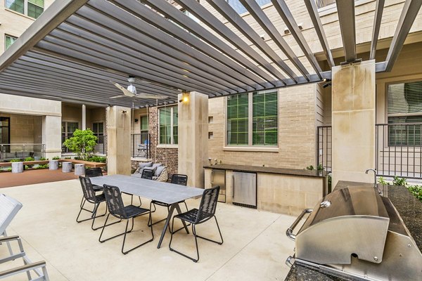 Modern grill area with seating at Elan Addison Grove Apartments, perfect for outdoor dining and entertaining