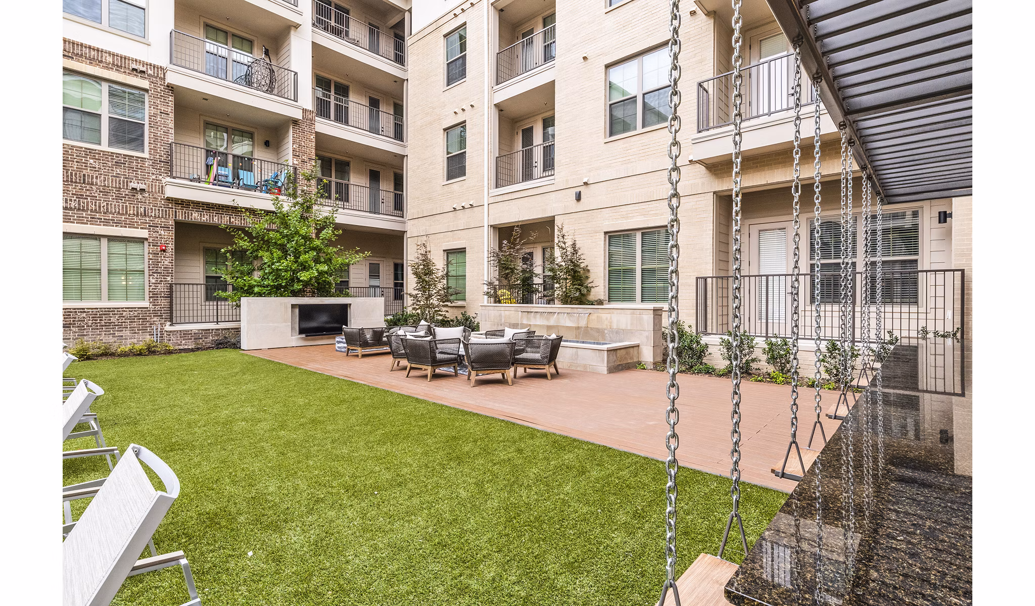 Private patio with stylish seating at Elan Addison Grove Apartments