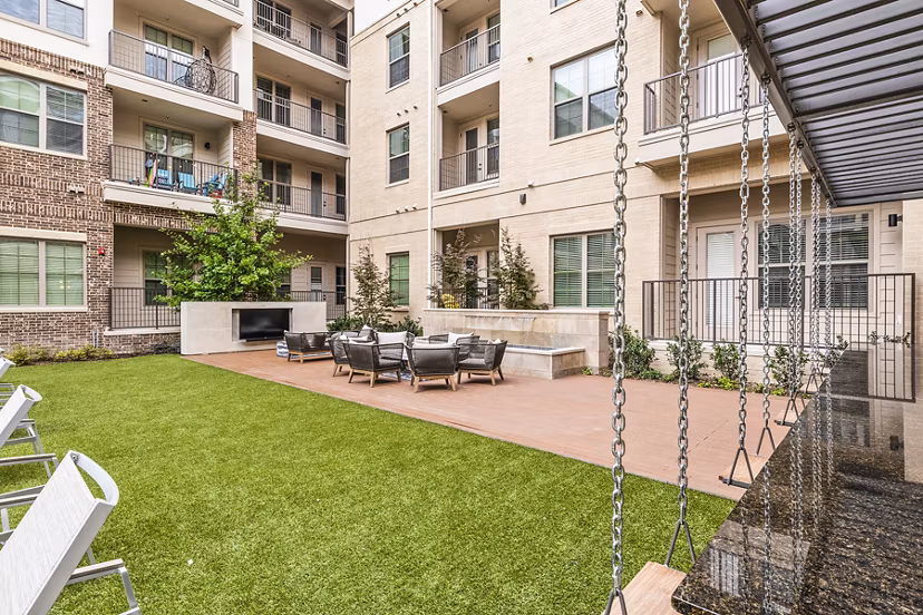 Private patio with stylish seating at Elan Addison Grove Apartments