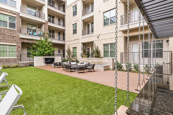 Private patio with stylish seating at Elan Addison Grove Apartments