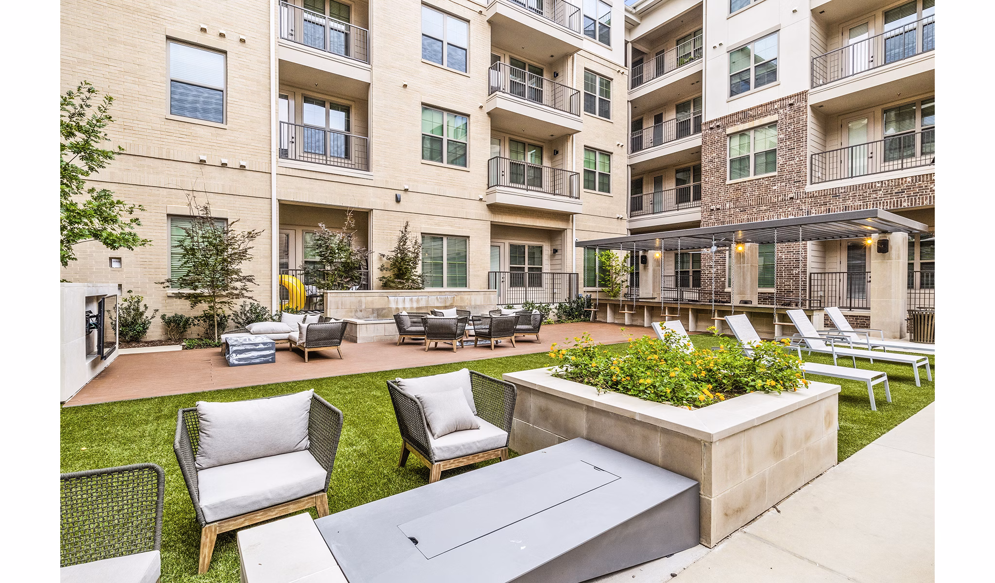 Elan Addison Grove Apartments: Spacious patio with outdoor seating and greenery
