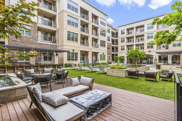 Outdoor pool and patio with lounge chairs at Elan Addison Grove Apartments