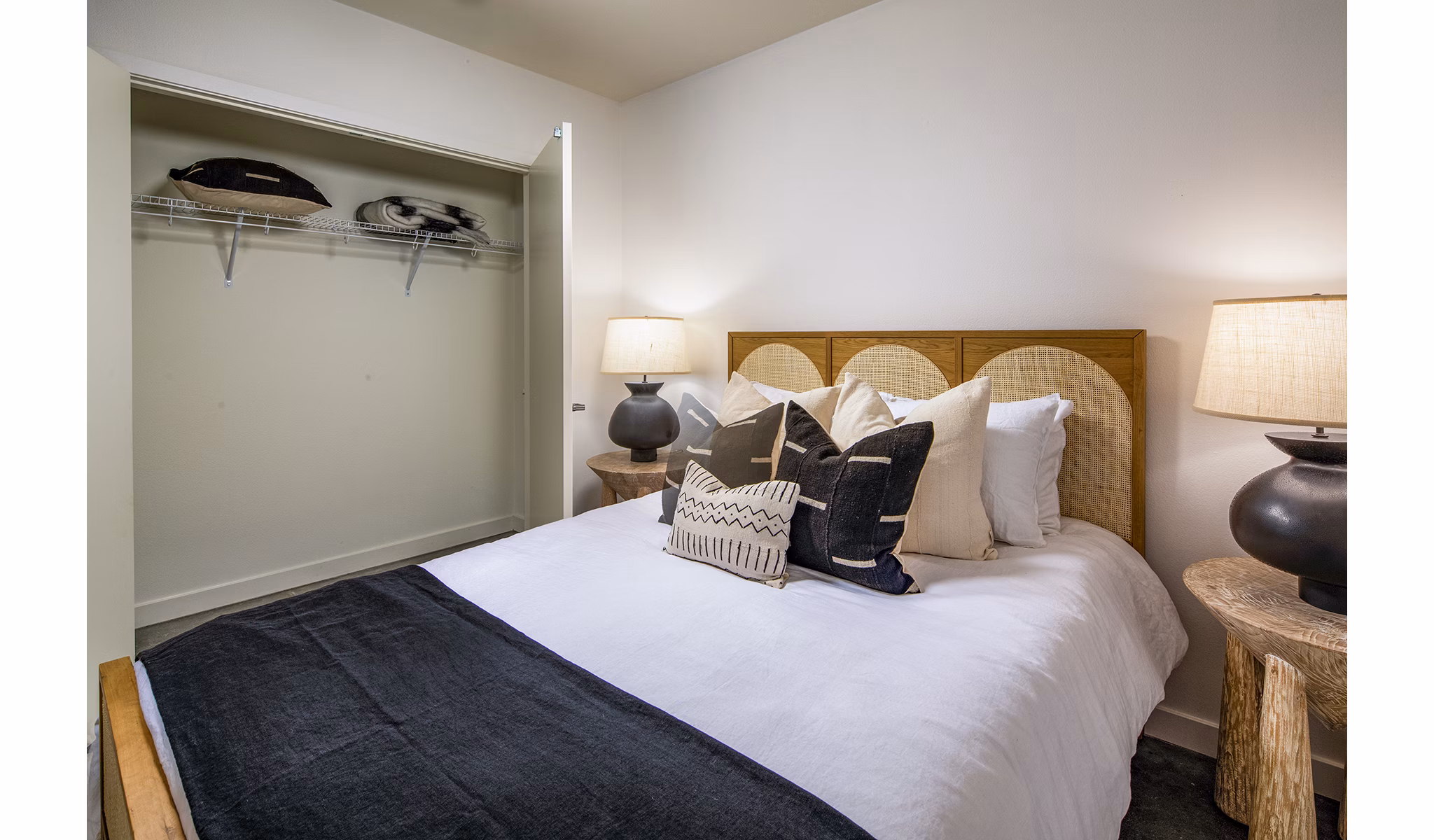 Bedroom with modern furnishings and large windows at Be DTLA Apartments, a luxurious living space in the heart of downtown Los Angeles