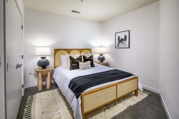 Stylish bedroom with city views at Be DTLA Apartments