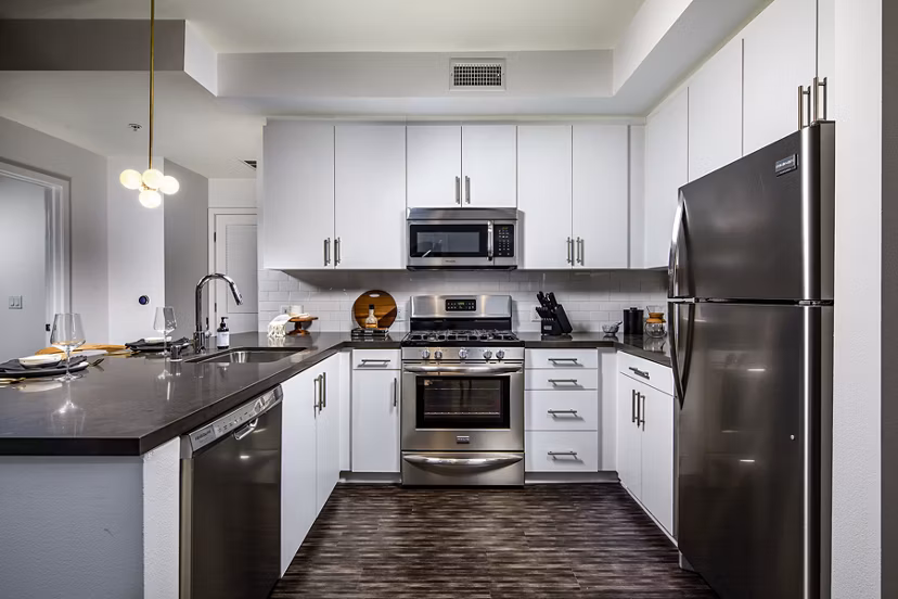 Modern kitchen with sleek countertops and stainless steel appliances in Be DTLA Apartments