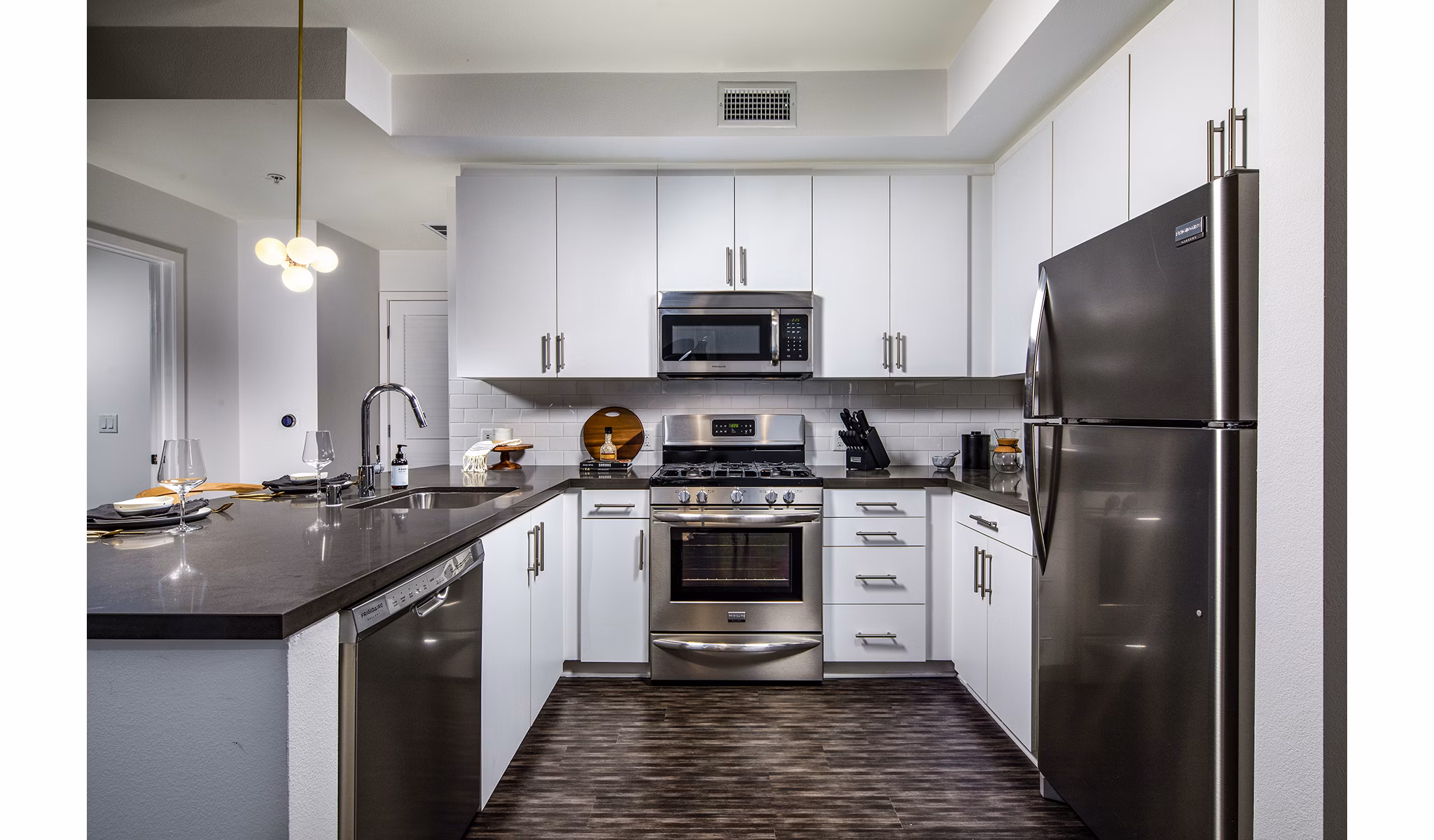 Modern kitchen with sleek countertops and stainless steel appliances in Be DTLA Apartments