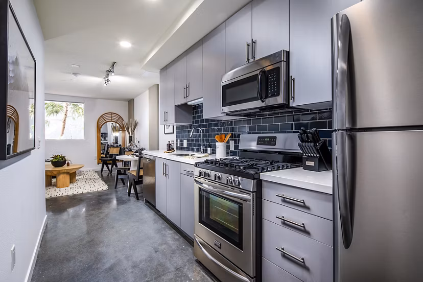 Modern kitchen with stainless steel appliances and island counter in Be DTLA Apartments