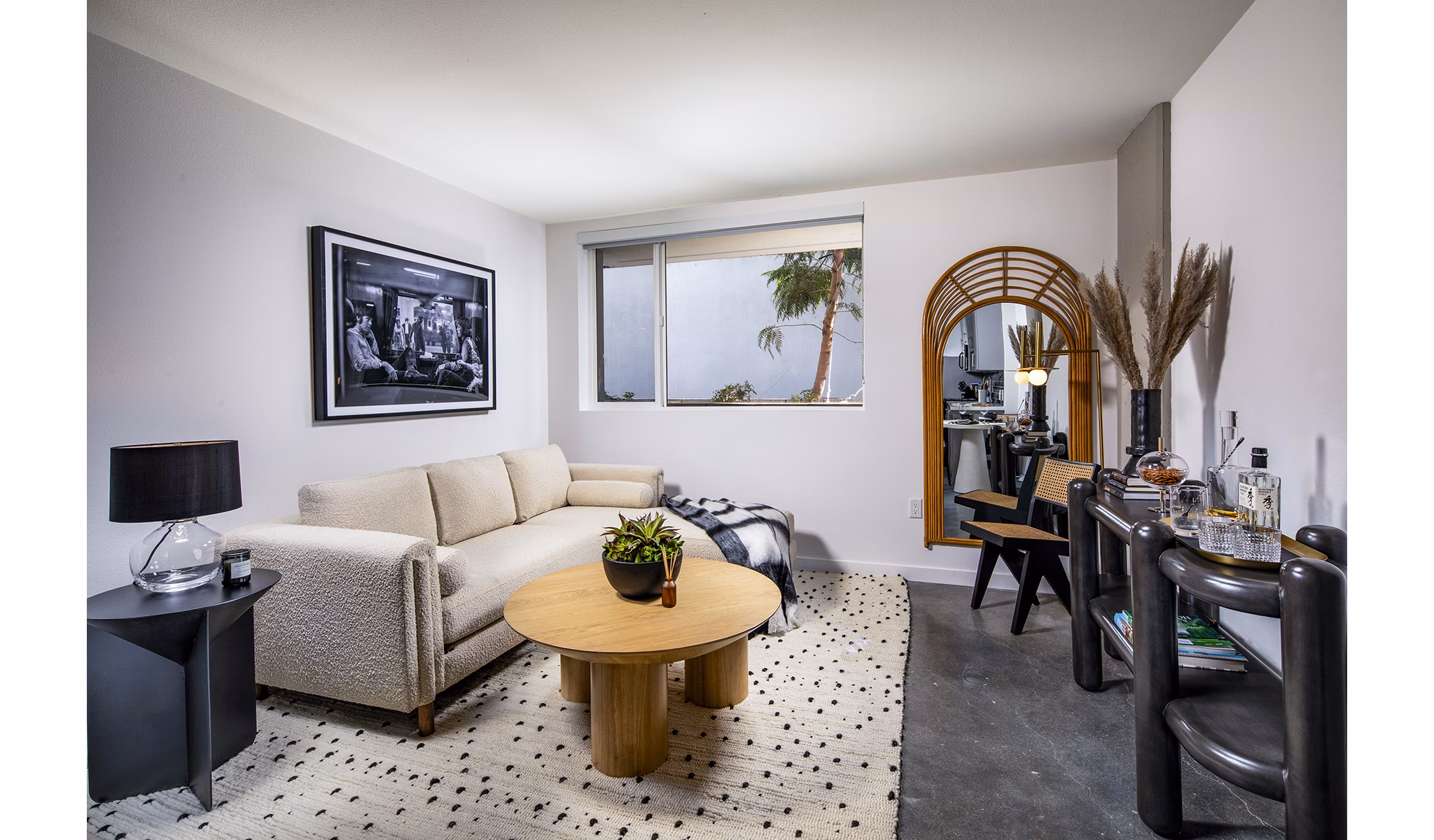 Modern living room with chic decor and ample natural light at Be DTLA Apartments