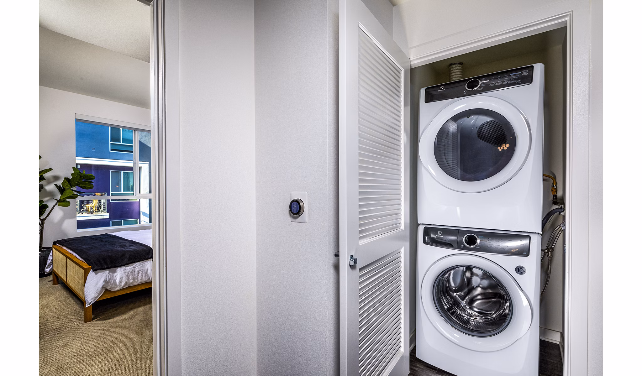 Modern laundry room with energy-efficient washers and dryers at Be DTLA Apartments