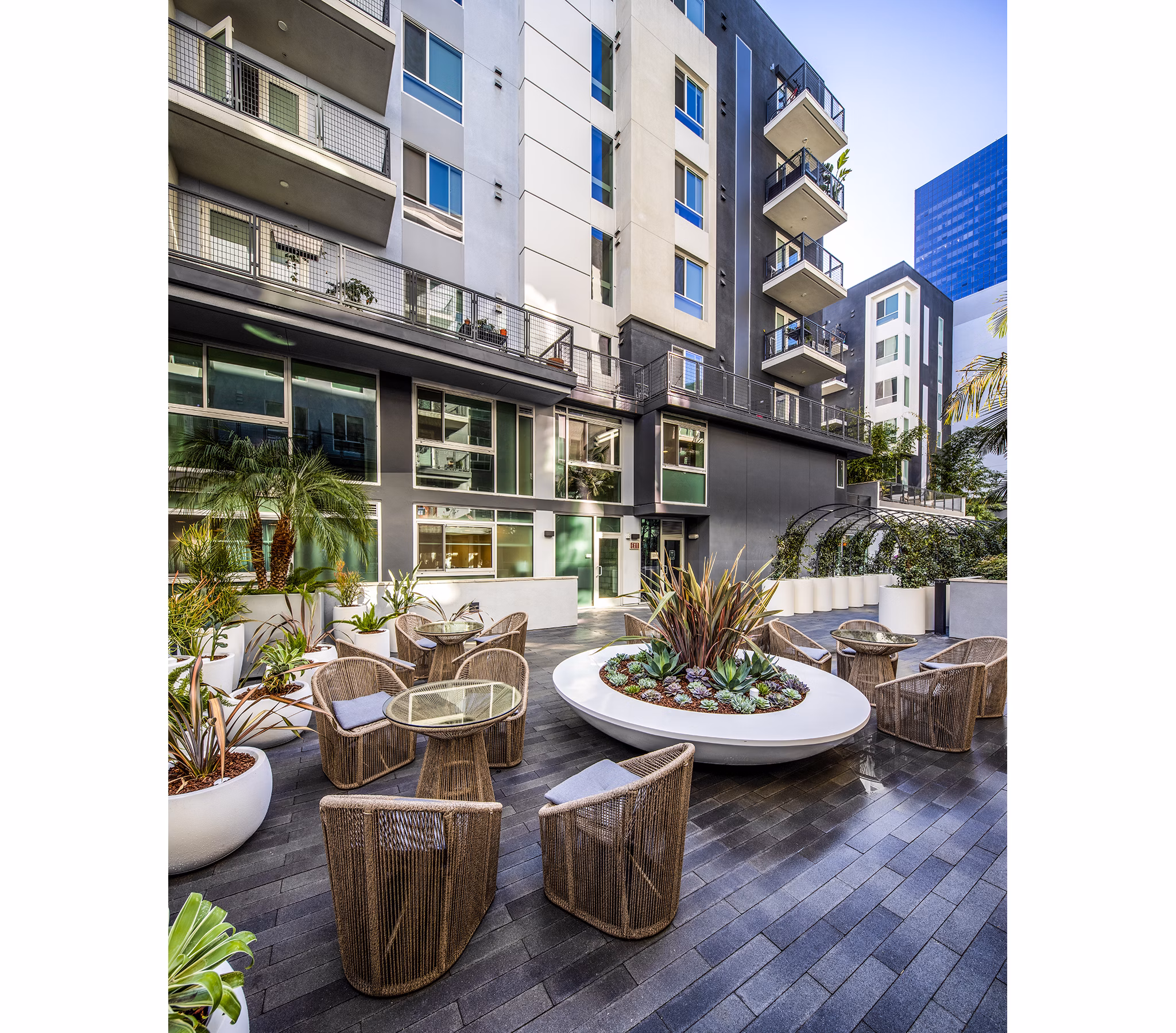 Spacious patio with modern furnishings at Be DTLA Apartments, perfect for outdoor relaxation and city views