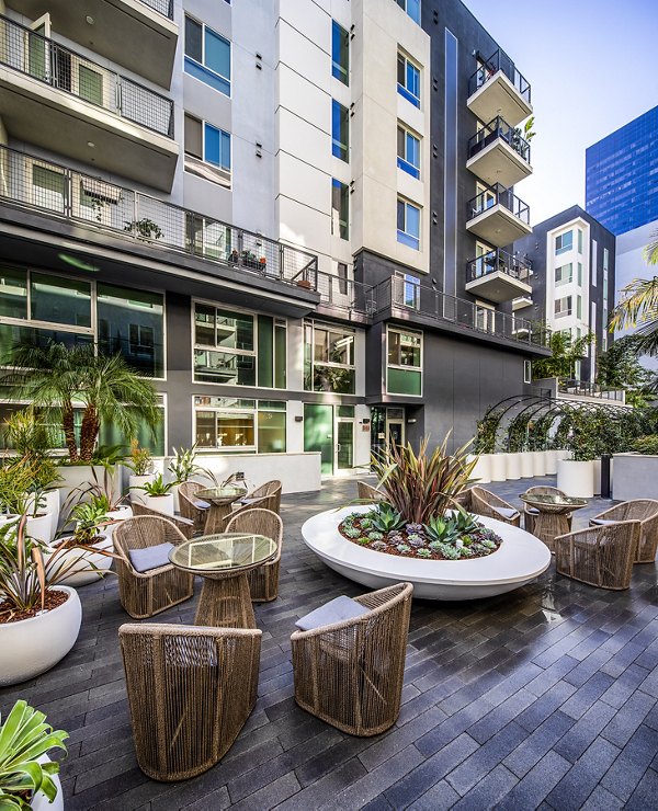 Spacious patio with modern furnishings at Be DTLA Apartments, perfect for outdoor relaxation and city views