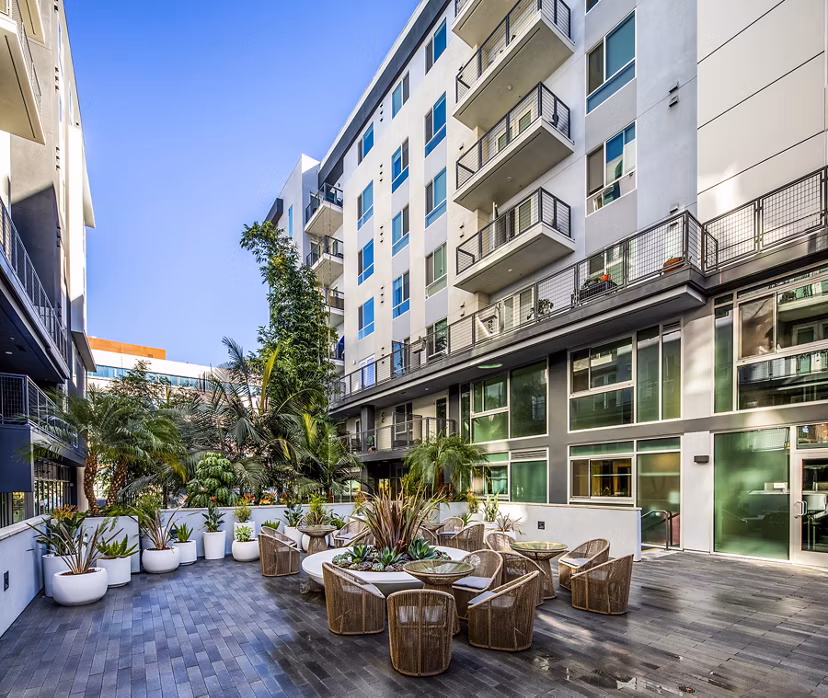 Outdoor patio with modern seating at Be DTLA Apartments offering city views in downtown Los Angeles