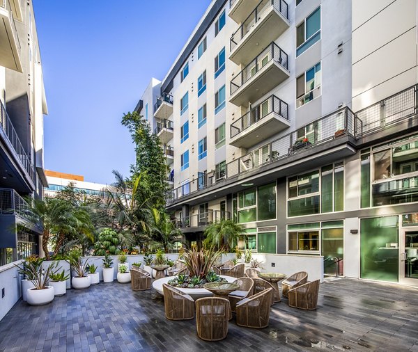 Outdoor patio with modern seating at Be DTLA Apartments offering city views in downtown Los Angeles