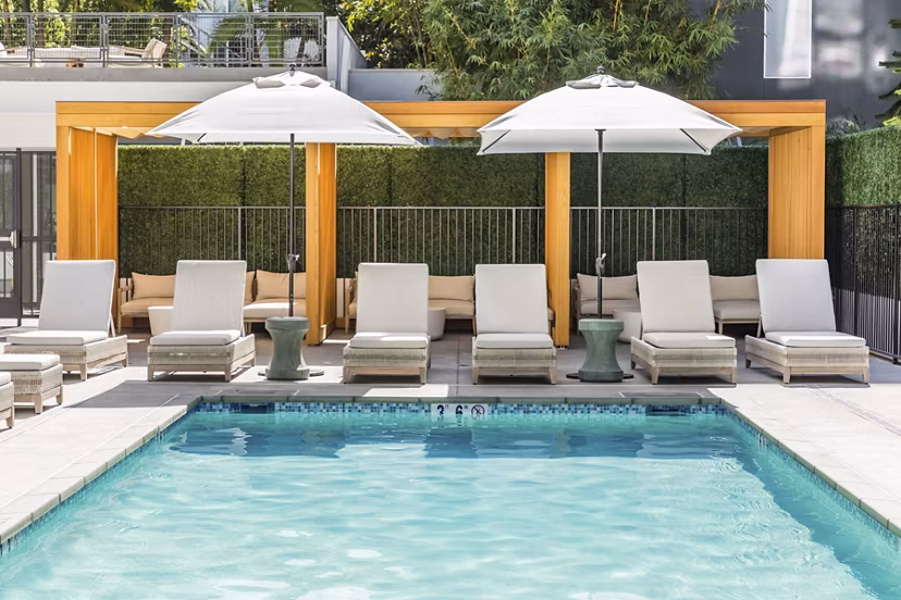 Luxury rooftop pool at Be DTLA Apartments with scenic views of Los Angeles skyline