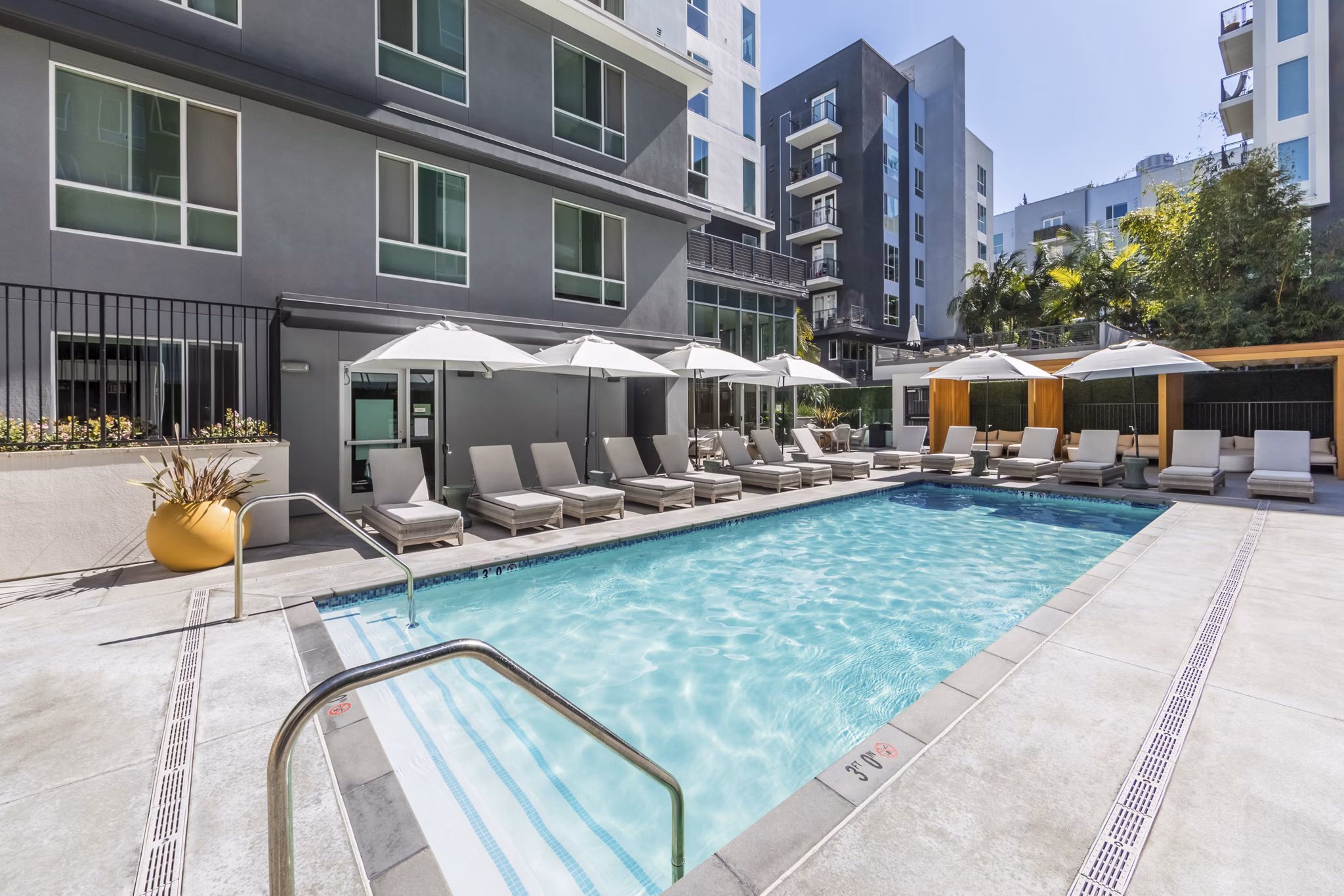 Poolside view at Be DTLA Apartments: Modern luxury apartments with a stunning swimming pool in the heart of downtown Los Angeles