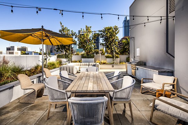 Grill area with modern BBQ setup at Be DTLA Apartments