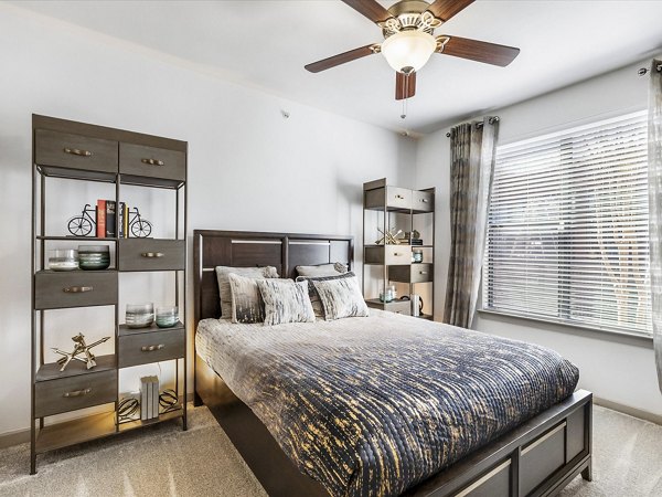 Luxurious bedroom with modern decor at The Avery on Southwestern Apartments in Houston