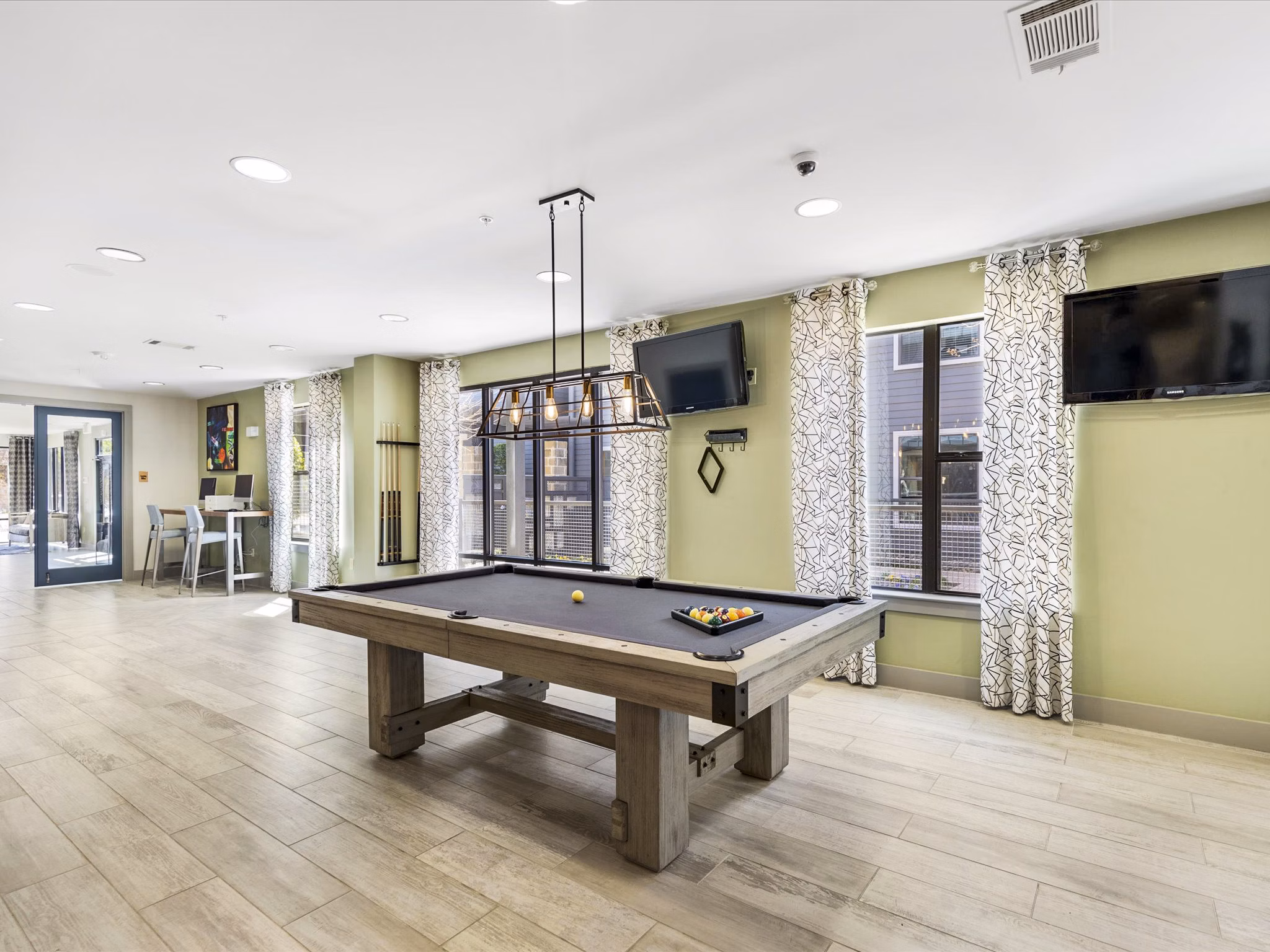 Chic clubhouse with modern decor at The Avery on Southwestern Apartments, perfect for gatherings and social events in Dallas, Texas