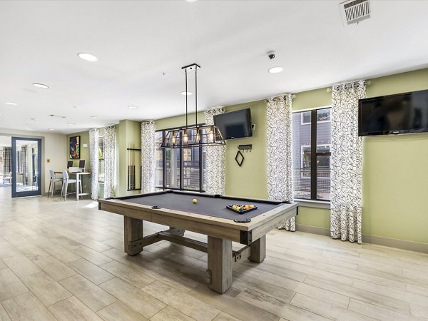 Chic clubhouse with modern decor at The Avery on Southwestern Apartments, perfect for gatherings and social events in Dallas, Texas