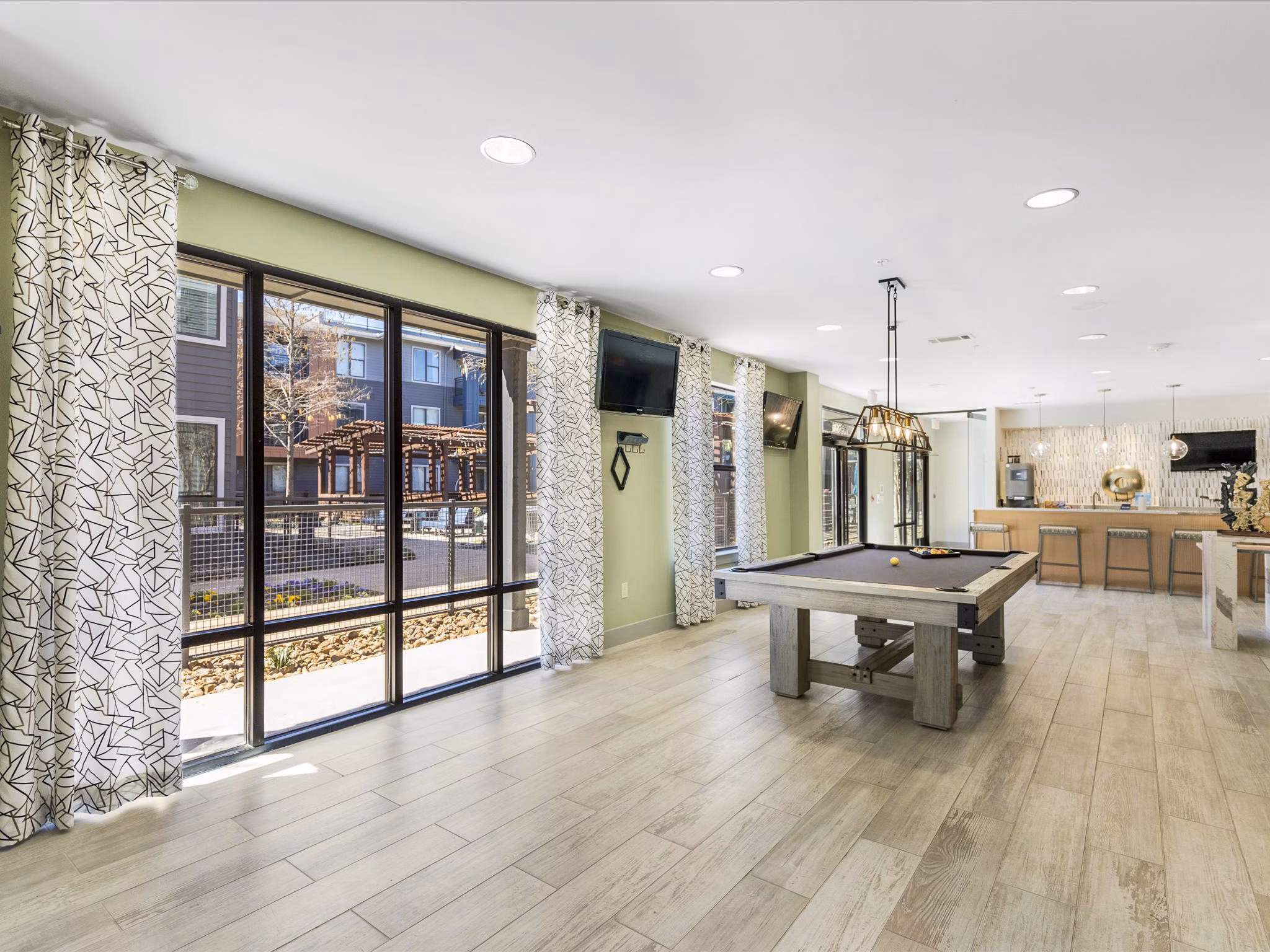The Avery on Southwestern: Modern clubhouse with luxurious seating and large screen TV in luxury apartments