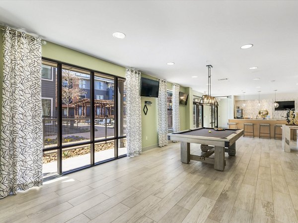 The Avery on Southwestern: Modern clubhouse with luxurious seating and large screen TV in luxury apartments
