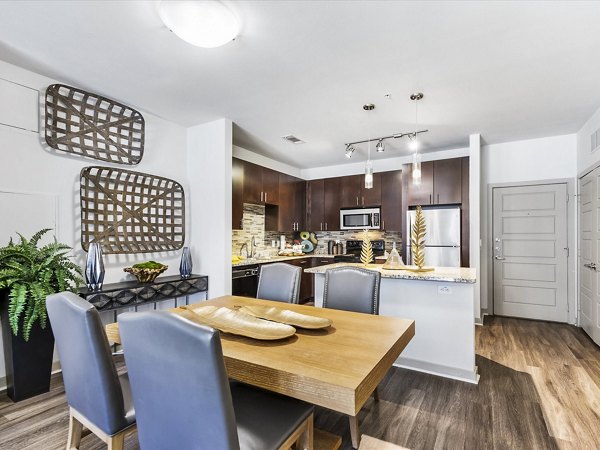 The Avery on Southwestern: Elegant dining room with modern decor and natural light, luxury apartments in the city