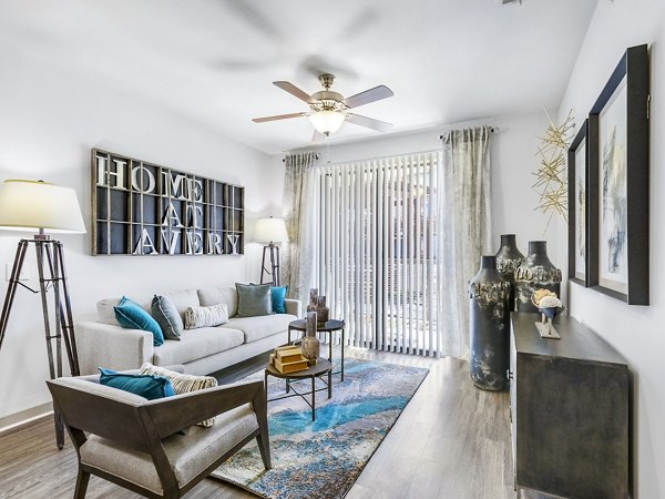 Spacious living room with modern decor in The Avery on Southwestern Apartments