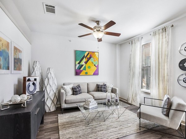 Spacious living room with modern decor in The Avery on Southwestern Apartments, perfect for relaxation and hosting activities