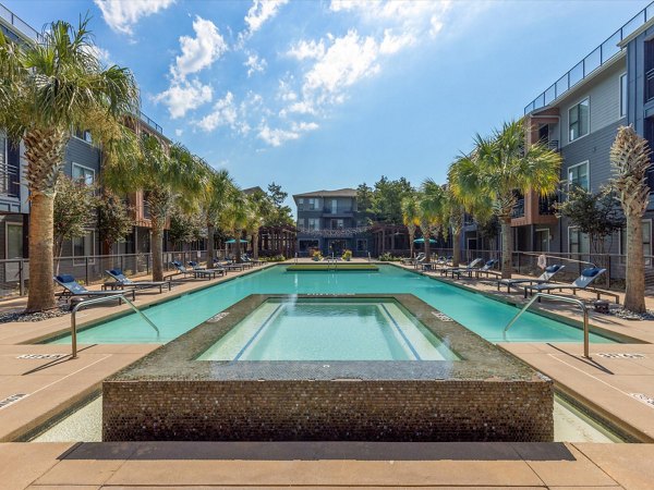Luxurious pool with cabanas at The Avery on Southwestern apartments