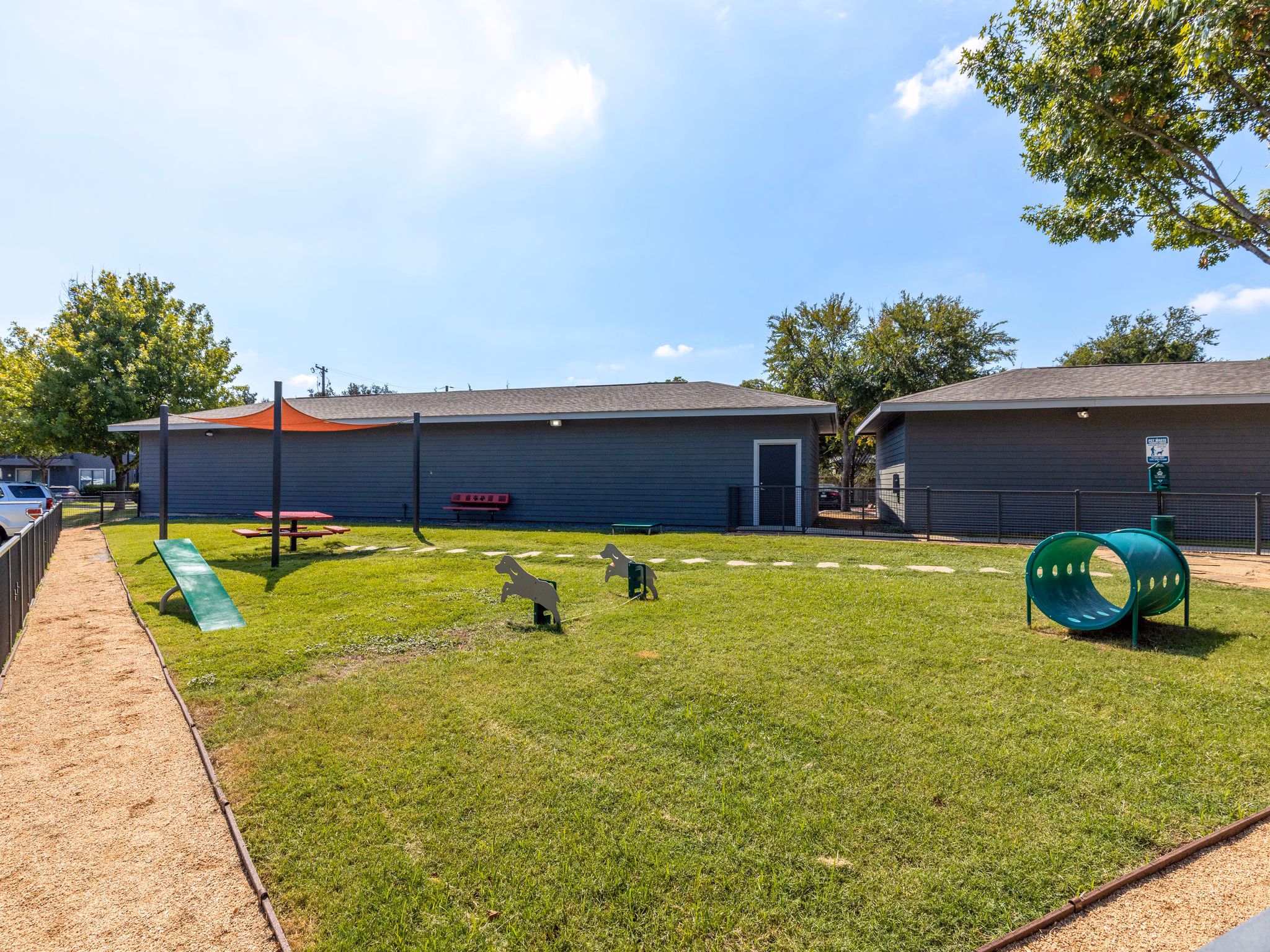Dog park with agility equipment at The Avery on Southwestern Apartments