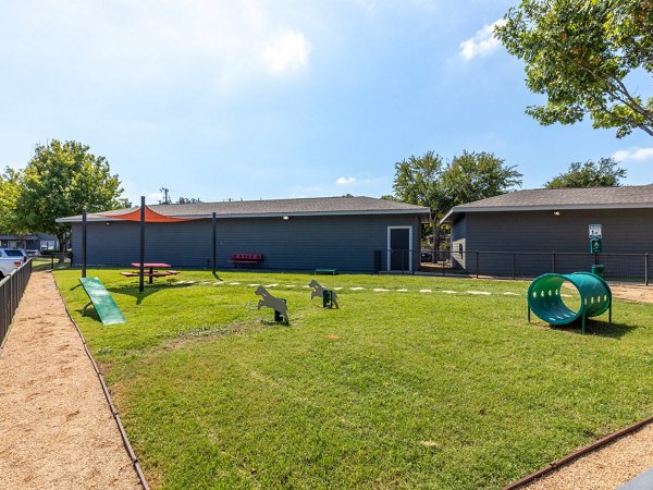 Dog park with agility equipment at The Avery on Southwestern Apartments