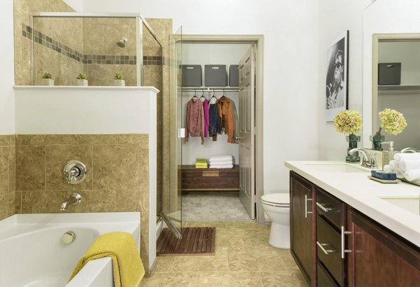 Elegant bathroom with modern fixtures featuring spacious vanity at Griffis at Lowry Apartments