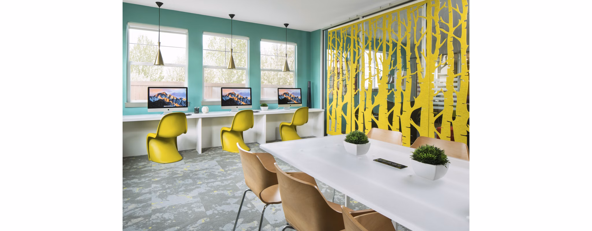 Modern business center with sleek workstations at Griffis at Lowry Apartments