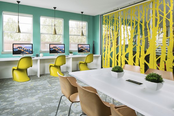 Modern business center with sleek workstations at Griffis at Lowry Apartments