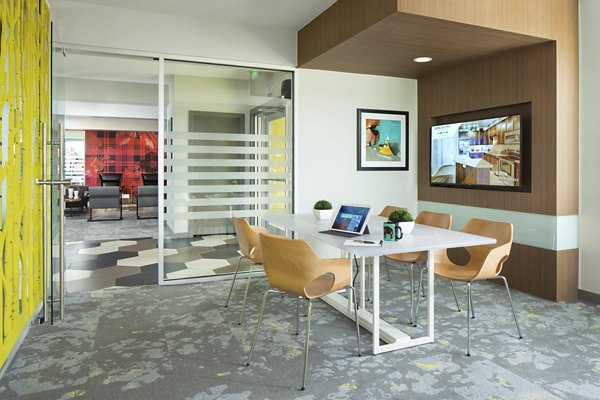Business center with modern workstations at Griffis at Lowry Apartments