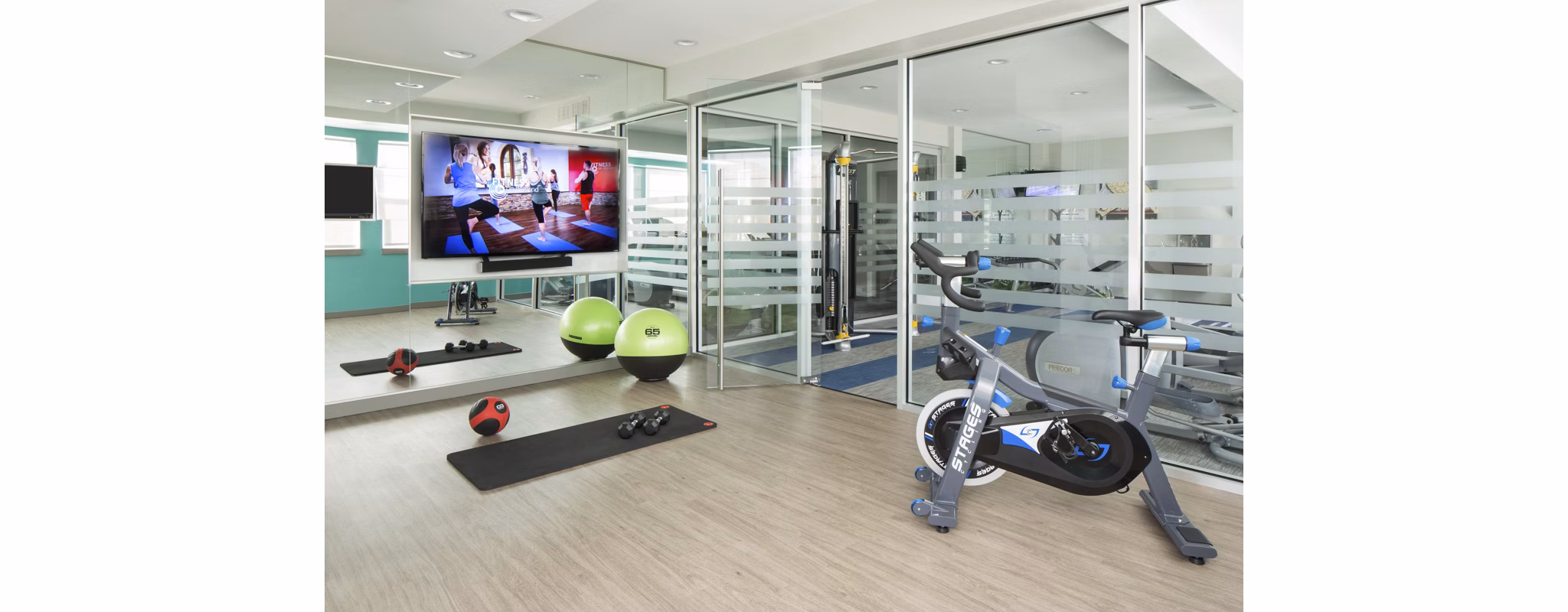 Spacious fitness center with modern equipment at Griffis at Lowry Apartments for luxury lifestyle enhancement