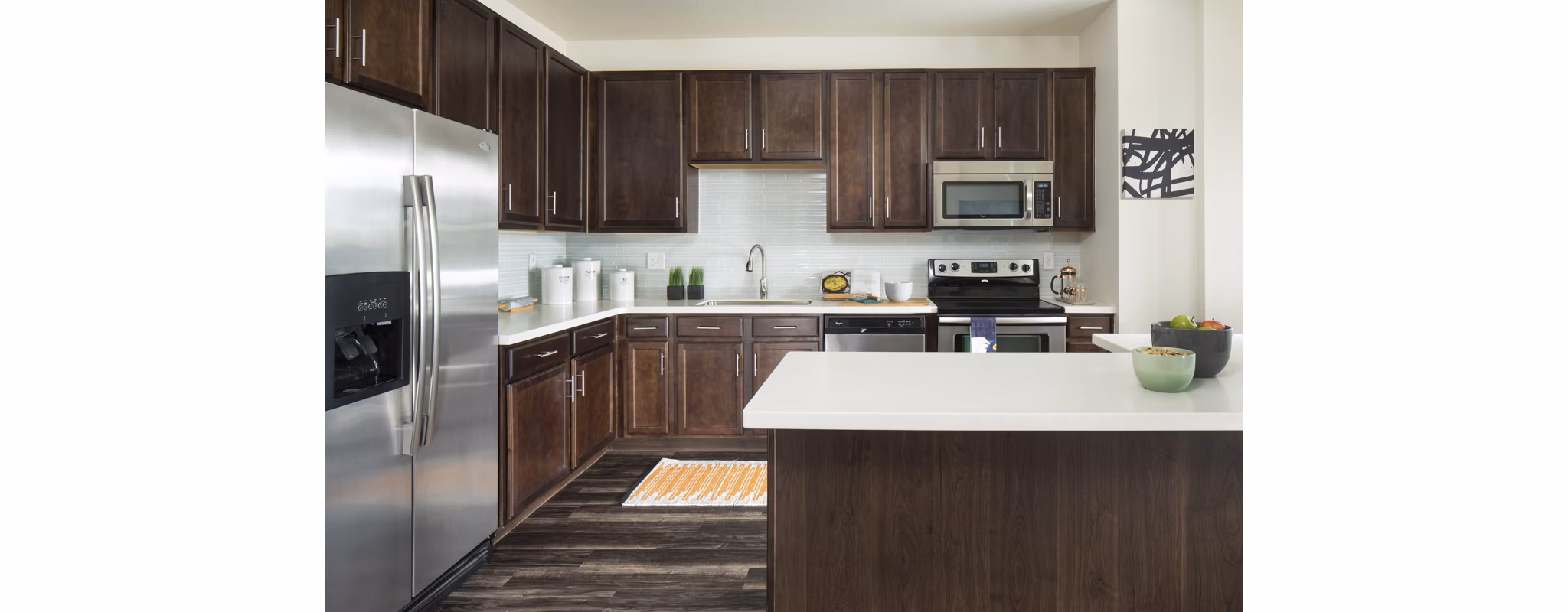 Modern kitchen with stainless steel appliances at Griffis at Lowry Apartments
