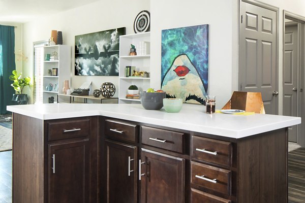 Griffis at Lowry Apartments: Modern kitchen with stainless steel appliances and quartz countertops