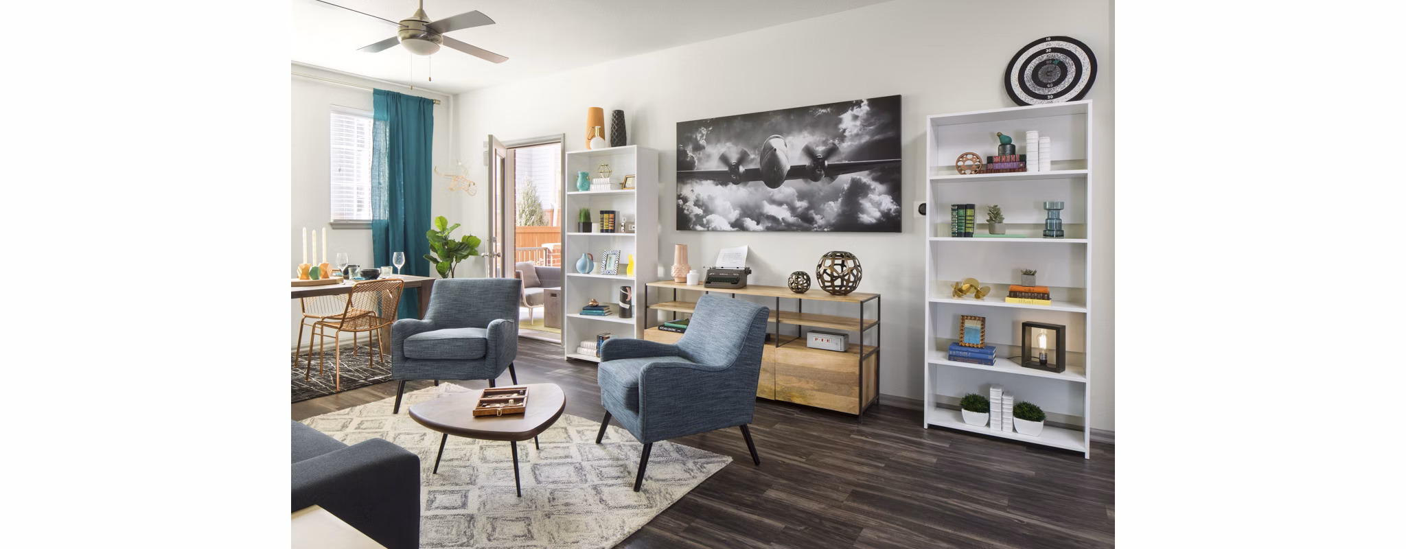 Modern living room with stylish decor and large windows at Griffis at Lowry Apartments