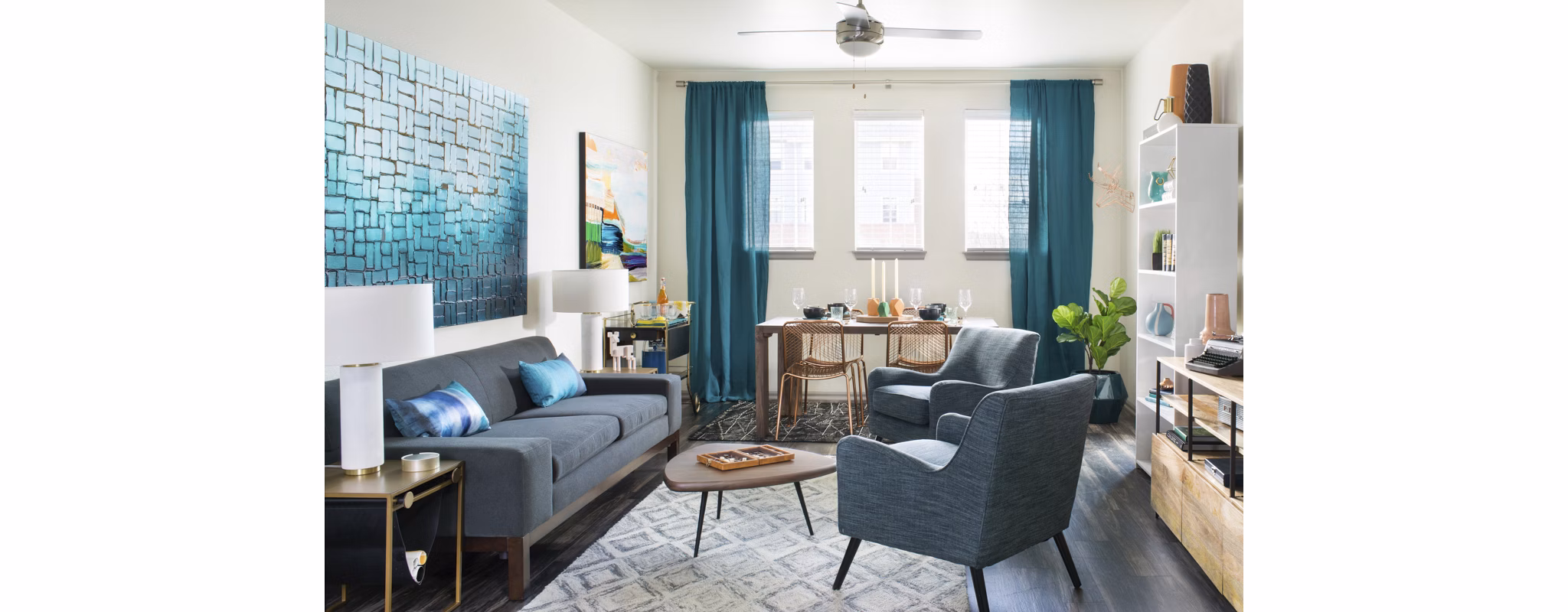 Cozy living room with modern decor at Griffis at Lowry Apartments, featuring plush seating and a stylish coffee table