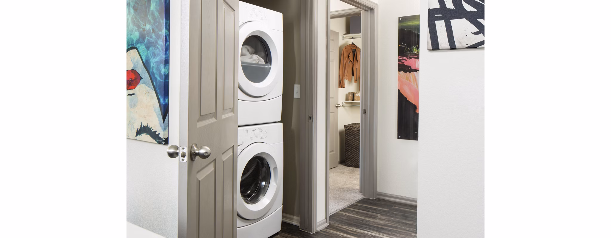 Laundry room with modern machines and ample storage at Griffis at Lowry Apartments, perfect for convenient and efficient laundry days