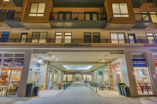 Welcoming entrance to luxury apartments with shops and restaurants below in a vibrant community
