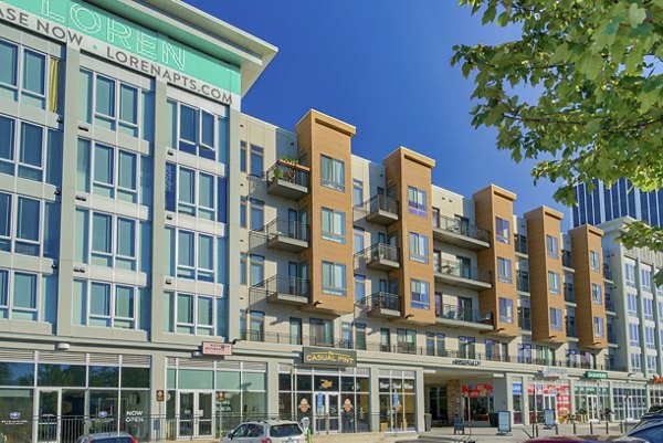 Modern apartment building with retail shops on the ground floor in a vibrant urban setting