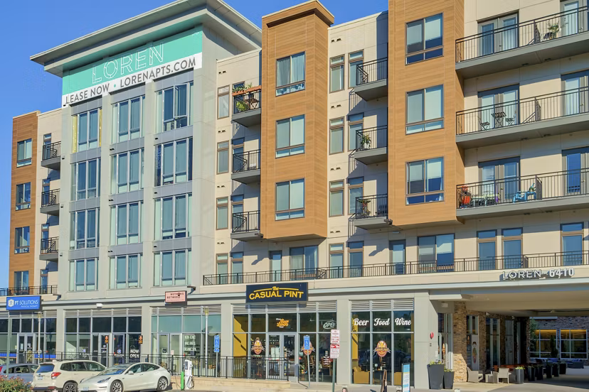 Modern luxury apartments with retail space, including Casual Pint, in a vibrant urban setting