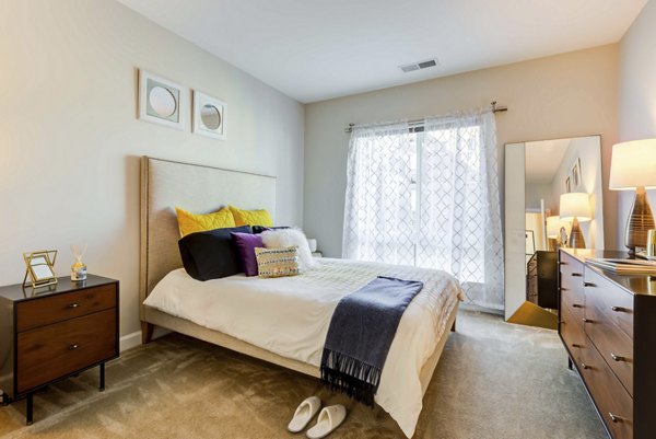 Stylish bedroom with contemporary decor in Loren Apartments, boasting luxury living spaces in prime downtown location