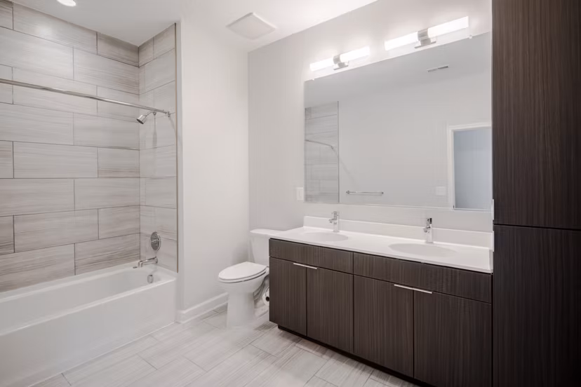 Bathrooms at Loren Apartments: Modern bathroom featuring sleek fixtures and spacious vanity in luxury Loren Apartments