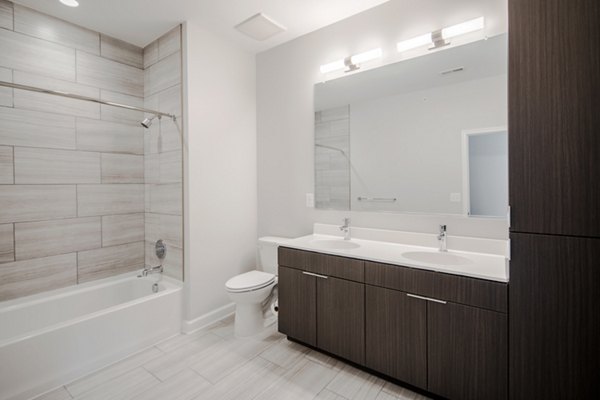 Bathrooms at Loren Apartments: Modern bathroom featuring sleek fixtures and spacious vanity in luxury Loren Apartments
