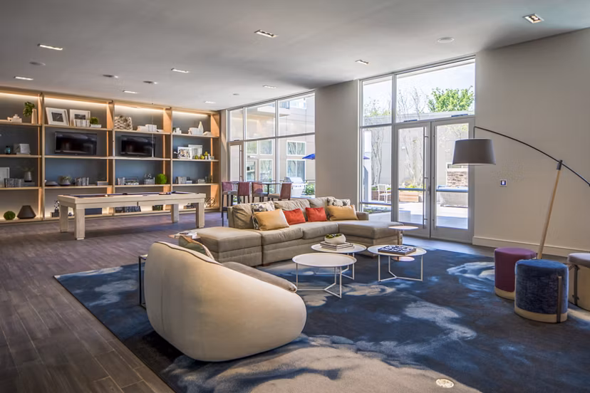 Loren Apartments: Stylish clubhouse featuring modern design and cozy seating areas in a luxury setting